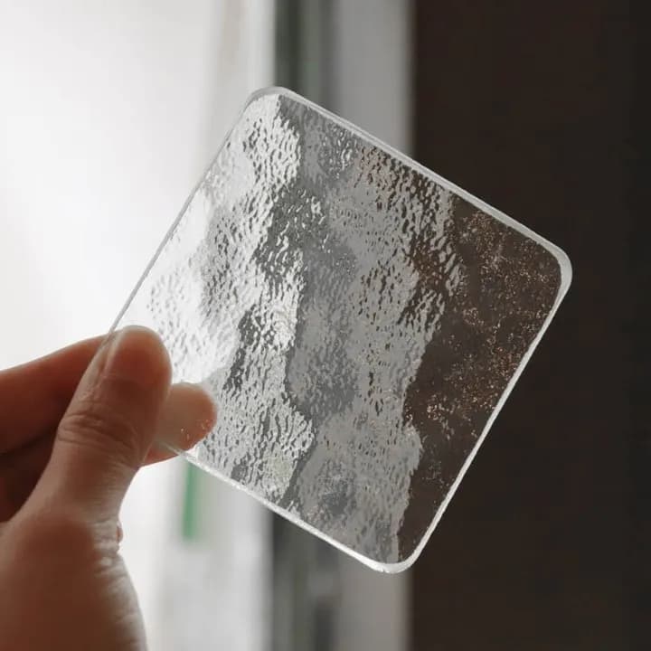 A transparent glass piece from Mingshun Glass with a textured surface.